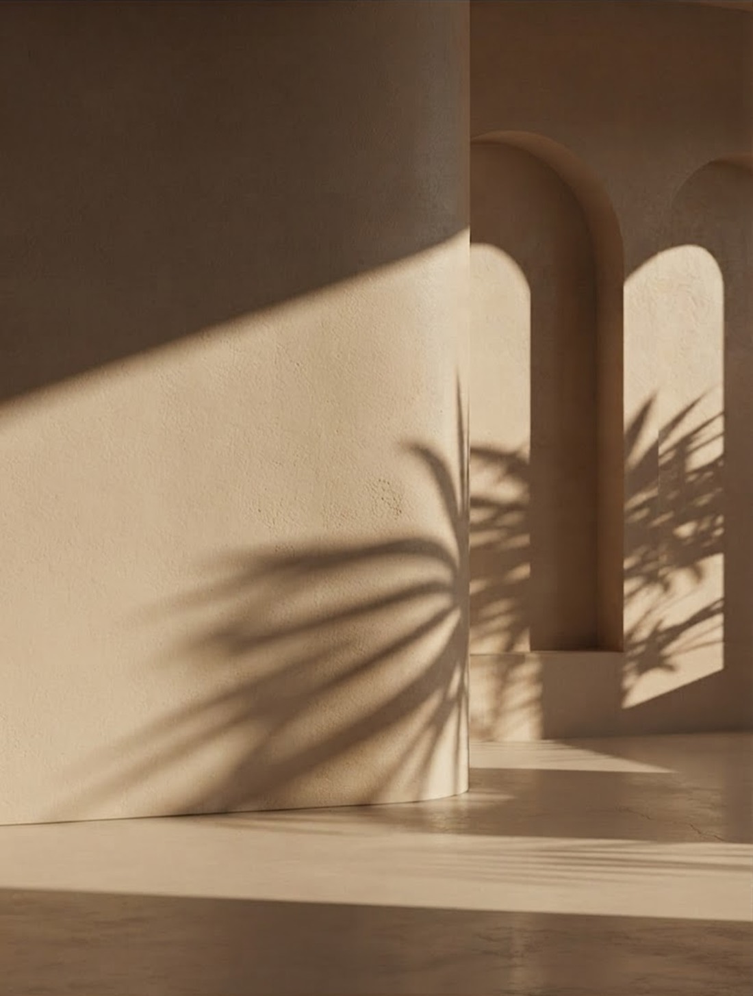 Sunlit plaster archways with a palm shadow falling across a curved wall — Arca Risk Management